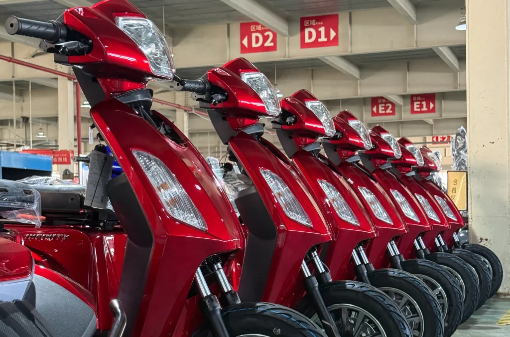 Rows of fully assembled and quality-inspected senior scooters stored in a warehouse ready for dispatch.