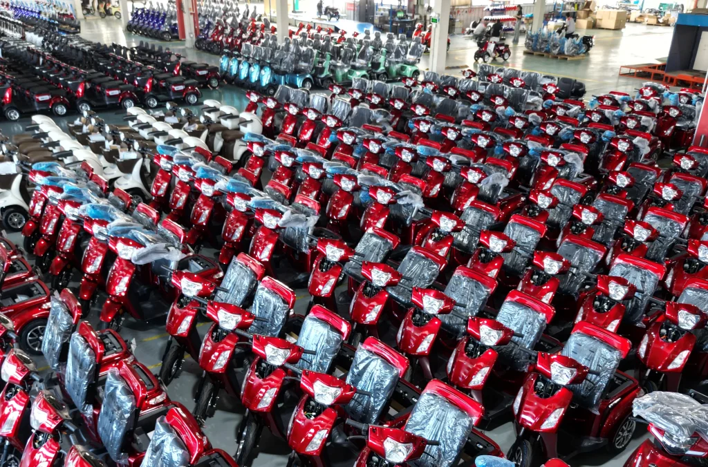 Factory showcase of multiple models including compact and long-range mobility scooter for sale options.